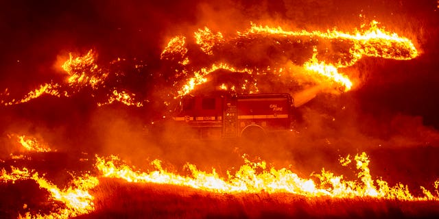 Firefighters light backfire while battling the Delta Fire in the Shasta-Trinity National Forest, Calif., on Thursday, Sept. 6, 2018.