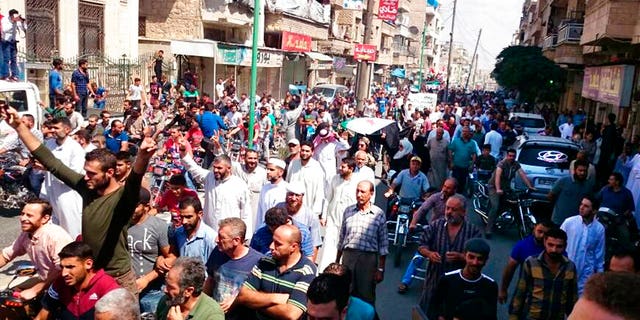 Protesters holding Syrian revolution flags and chanting, in Maaret al-Numan, a town in Idlib province, Syria, Friday, Sept 7, 2018; The Friday rallies came as Presidents of Iran, Turkey and Russia are meeting in Tehran to discuss the war in Syria