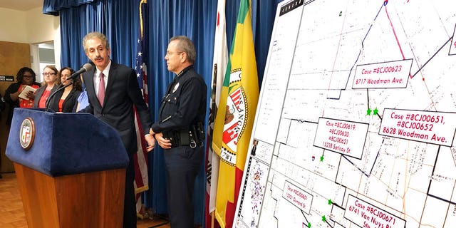 Los Angeles City Attorney Mike Feuer, at podium, and police Chief Michel Moore announce that prosecutors have charged more than 500 people with misdemeanors for illegal marijuana operations, at a news conference in Los Angeles, Sept. 7, 2018.