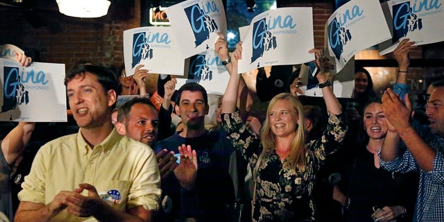 Supporters of incumbent Democratic Rhode Island Gov. Gina Raimondo cheer as they watch results on TV at her primary night party.