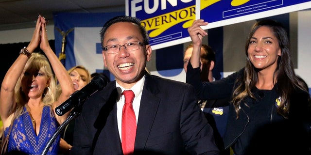 FILE: Cranston, R.I., Mayor Allan Fung, center, celebrates victory over R.I. House Minority Leader Patricia Morgan in the Republican gubernatorial primary.