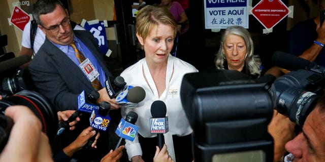 FILE: New York gubernatorial candidate Cynthia Nixon, center, speaks to members of the media outside a polling station after voting in the primary.