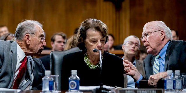 Senate Judiciary Committee Chairman Chuck Grassley (left) confers with other committee members, Sens. Patrick Leahy and Dianne Feinstein, the ranking member.