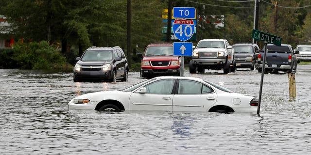 Drivers tried to navigate a flooded road leading to Interstate 40 in Castle Hayne, N.C., after damage from Florence cut off access to Wilmington, N.C., on Sunday.