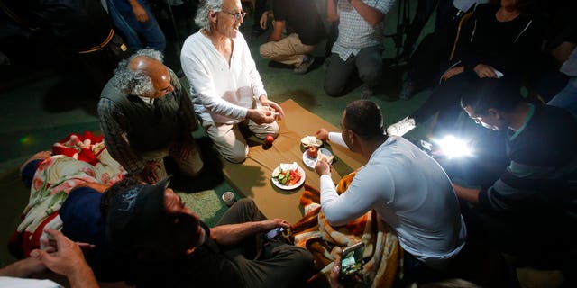FILE: Frank Roimano is eating breakfast in the West Bank community of Khan al-Ahmar after being released from Israeli police custody.