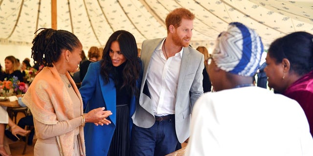 Prince Harry Kisses a Fan With Meghan Markle Nearby