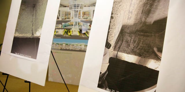Photographs showing a cracked steel beam found in the Salesforce Transit Center are displayed during a news conference.