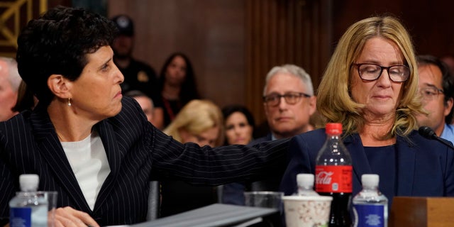 Attorney Debra Katz puts her hand on Christine Blasey Ford as she testifies before the Senate Judiciary Committee.