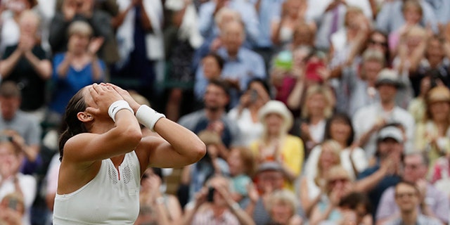 Spain's Garbine Muguruza celebrates after beating Venus Williams of the United States to win the Women's Singles final match on day twelve at the Wimbledon Tennis Championships in London Saturday, July 15, 2017.