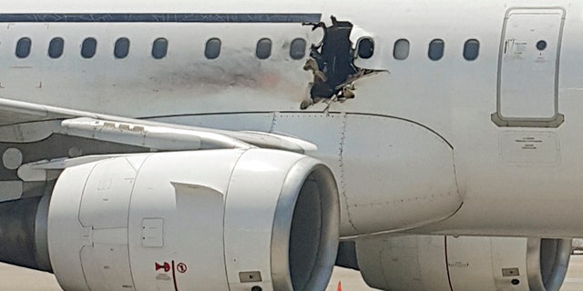 The damaged passenger jet after its emergency landing in Mogadishu.