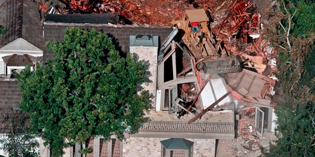 Crews demolish the former home of O.J. Simpson in July of 1998.