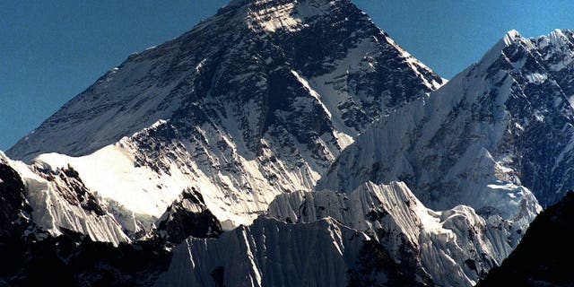 FILE - In this October 1996 file photo, Mount Everest is seen from peak Gokyo Ri in Nepal. Chinese state-run mobile news site The Paper reported Wednesday, May 11, 2016, that workers had removed the signatures, dates, doodles and messages left by scores of visitors on two granite tablets on the Chinese side of Mount Everest's northern base camp and plan to name and shame future defilers.(AP Photo/Hans Edinger)