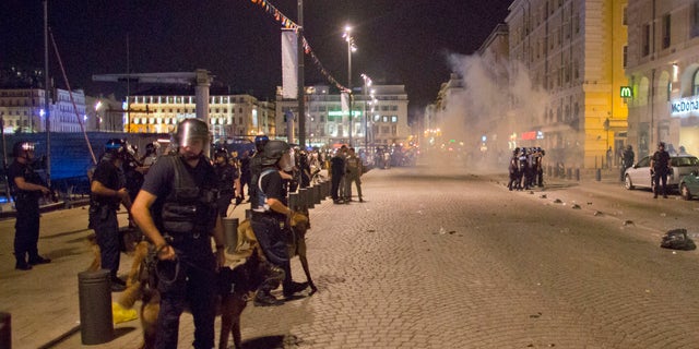 Police unleash tear gas in Marseille early Friday.