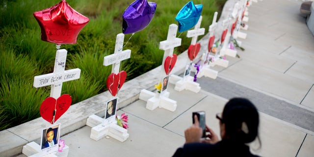 Crosses, one for each victim, line a walkway as a memorial to those killed in the Pulse nightclub mass shooting a few blocks from the club early Friday, June 17, 2016, in Orlando, Fla. (AP Photo/David Goldman)