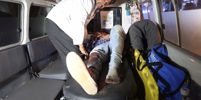 A wounded person treated in an ambulance.