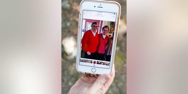 Jamie Sample shows a photo taken December 2015, showing Sisters Paula Merrill, left, and Margaret Held.