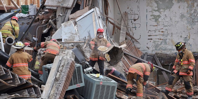 Emergency crews clear debris at the scene of the building collapse in Sioux Falls.