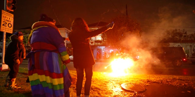 Partiers launch fireworks before boarding the Rampart-St. Claude street car line.
