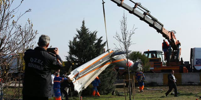 Firefighters removing the wreckage.