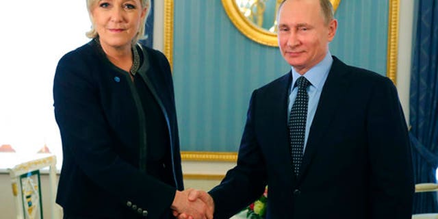 Russian President Vladimir Putin shaking hands with far-right French presidential candidate Marine Le Pen last week.