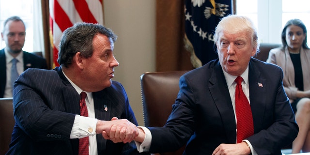 President Donald Trump shakes hands with New Jersey Governor Chris Christie at an opioid and addiction session.