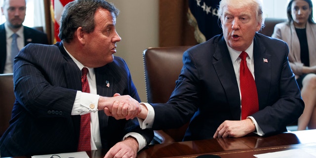 President Donald Trump shakes hands with New Jersey Gov. Chris Christie during an opioid and drug abuse listening session.