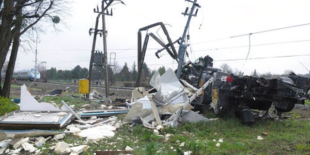 The damaged flat-bed truck.
