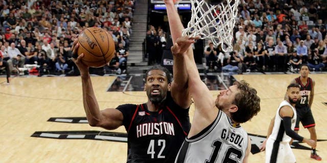 Houston Rockets center Nene Hilario (42) goes up for a shot as San Antonio Spurs' Pau Gasol (16) of Spain defends during the second half of Game 2 in a second-round NBA playoff series basketball game, Wednesday, May 3, 2017, in San Antonio. (AP Photo/Eric Gay)
