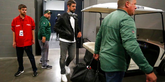 Green Bay Packers quarterback Aaron Rodgers, center, leaves the locker room after an NFL football game against the Minnesota Vikings in Minneapolis, Sunday, Oct. 15, 2017. Rodgers broke his collarbone in the first half. (AP Photo/Bruce Kluckhohn)