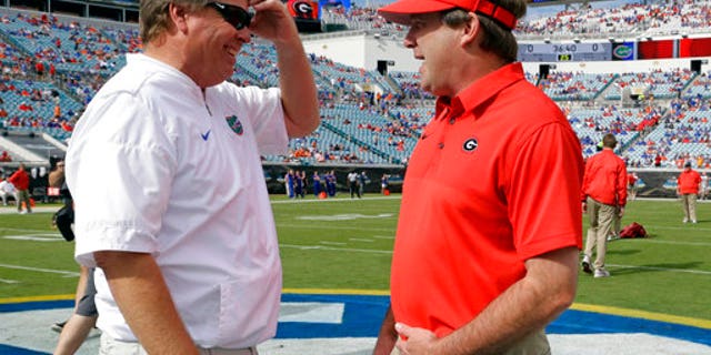 Florida head coach Jim McElwain, left, with Georgia head coach Kirby Smart on Saturday.