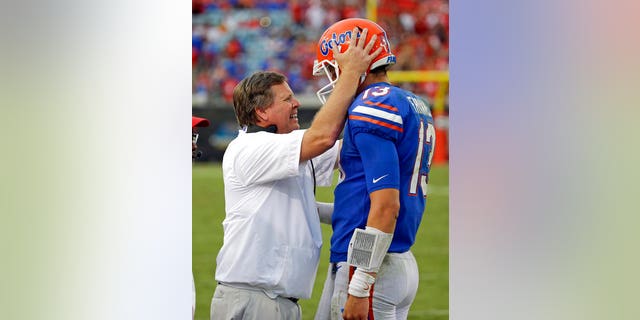 Florida head coach Jim McElwain talking on the sideline with quarterback Feleipe Franks on Saturday.