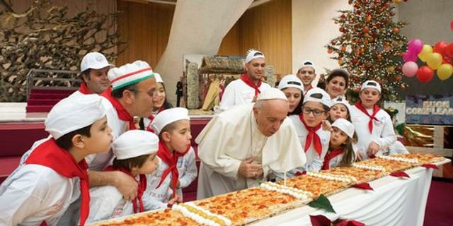 Pope Francis blowing out the candle at the Vatican.