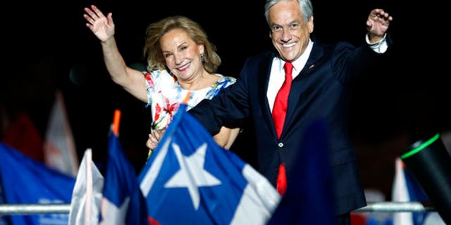 Chile's former President Sebastian Pinera and his wife Cecilia Morel wave to supporters as they celebrate Pinera's winning the presidential election runoff in Santiago, Chile.