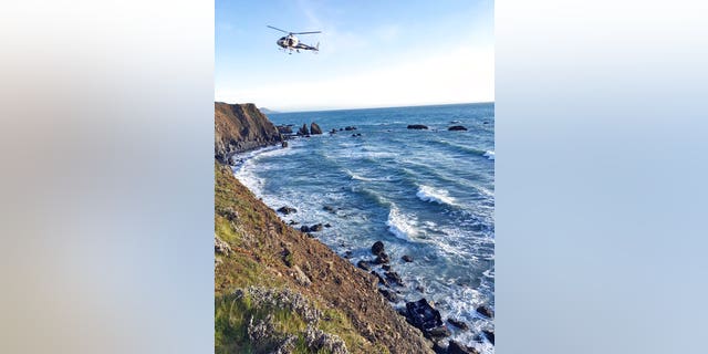 A helicopter hovers over the Northern California site where the Hart family's SUV was discovered Monday afternoon.