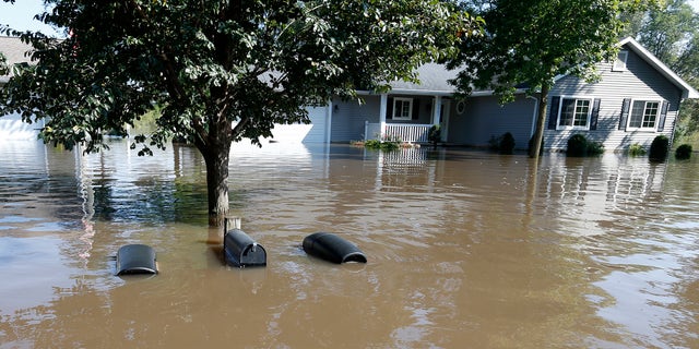 The tops of mailboxes barely break the surface of floodwaters from the Cedar River in the North Cedar neighborhood of Cedar Falls over the weekend.