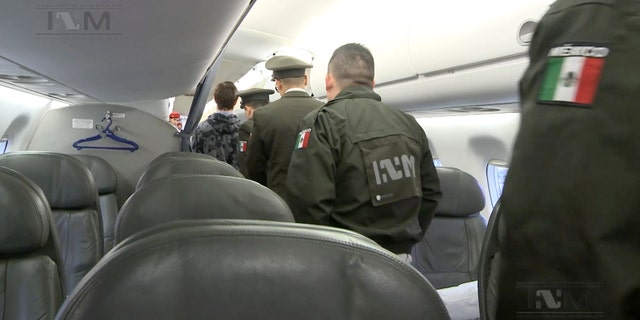 Ethan Couch escorted onto the plane by Mexican immigration agents.
