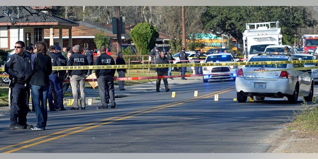 Officers investigating the shooting scene on Saturday.