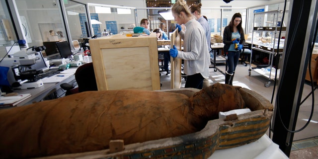 A technician a secure a crate of artifacts at the Penn Museum Thursday.