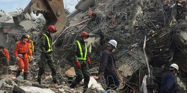 Rescue teams digging through the rubble of collapsed buildings Thursday.