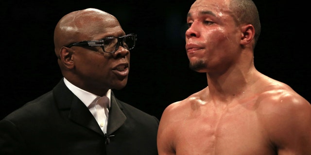 Chris Eubank, Sr., left, speaking to his son Chris Eubank, Jr. during a fight in February.
