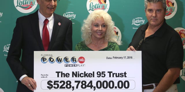 Florida Lottery Secretary Tom Delacenserie (left) with winners Maureen Smith and David Kaltschmidt.