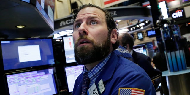 Michael Pistillo Jr. follows stock prices at the New York Stock Exchange, Friday, Jan. 15, 2016. (AP Photo/Mark Lennihan)