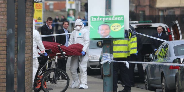The body of Eddie Hutch is removed from a property in Dublin Tuesday.