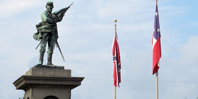Confederate flags fly near a monument at Magnolia Cemetery in Charleston., S.C., on Tuesday, May 10, 2016. On this day in 1863, Confederate Gen. Thomas "Stonewall" Jackson died. May 10 is observed as Confederate Memorial Day in the Carolinas. (AP Photo/Bruce Smith)