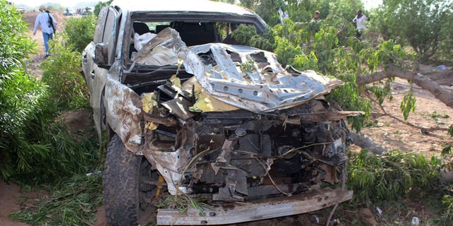 A damaged car is seen at the site of a car bomb attack in the southern port city of Aden, Yemen, Tuesday, Jan. 5, 2016. Yemeni officials say the governor of the southern port city of Aden has survived a car bomb attack that killed two and critically wounded three of his bodyguards. (AP Photo/Wael Qubady)