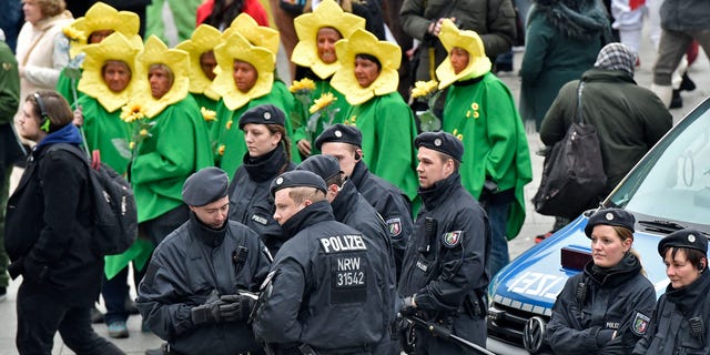 Police patrols in front of the main station during the start of the street carnival in Cologne, Germany on Thursday.
