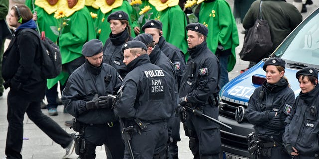 Police patrols in front of the main station during the start of the street carnival in Cologne, Germany on Thursday.