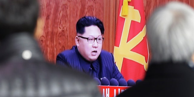 South Koreans watch a TV news program showing North Korean leader Kim Jong Un's New Year speech, in Seoul.