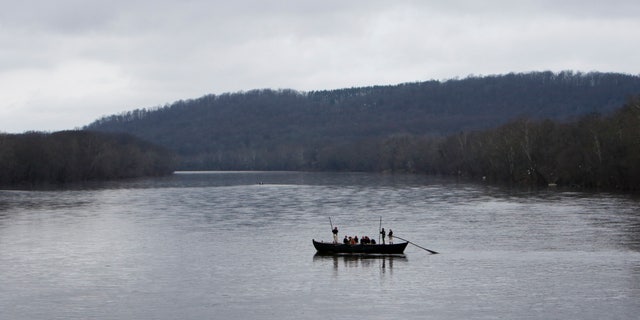 A group of Revolutionary War re-enactors row a Durham boat during the re-enactment of Washington crossing the Delaware River, Friday, Dec. 25, 2015, in Washington Crossing, Pa. (AP Photo/ Joseph Kaczmarek)