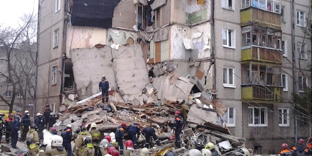 In this photo provided by the Yaroslavl Branch of Russian Emergency Ministry Press Service, emergency and rescue workers search the debris of a 5-story apartment building after a powerful natural gas explosion early Tuesday, Feb. 16, 2016, in Yaroslavl, Russia. (Russian Emergency Ministry Yaroslavl Branch Press Service via AP)